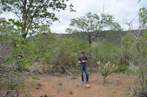 Kovach in the field, standing by a cactus