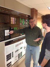 Darren Seals with a student looking at a research poster