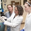 Dr. Karatan with two students