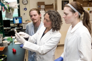Dr. Karatan with two students