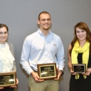 3 minute thesis competition winners with award plaques