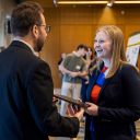 Addison Pollock, of Winston-Salem, a senior biology-cellular/molecular biology major at App State, right in foreground, accepts her award from Dr. Ross Gosky, associate dean of the Williams School of Graduate Studies, at the university’s 28th Annual Celebration of Student Research and Creative Endeavors, held April 16 on the Boone campus. Pollock’s research involves the study of how cancer cells respond to oncolytic viruses. Photo by Kyla Willoughby