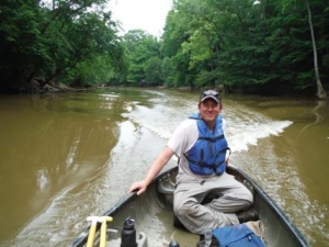 Mike Gangloff in a boat on a river